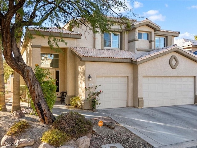 mediterranean / spanish-style house with a garage