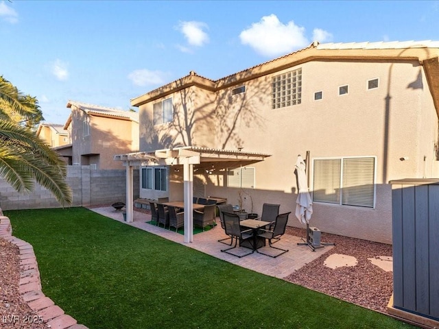 back of house with a pergola, a patio area, and a lawn