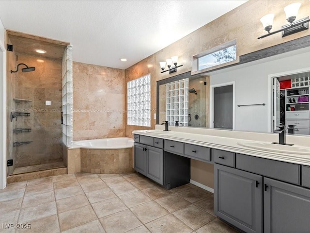 bathroom featuring vanity, independent shower and bath, and tile patterned flooring