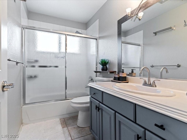 full bathroom with vanity, combined bath / shower with glass door, and toilet