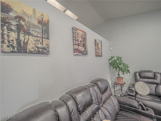 living room with vaulted ceiling with skylight