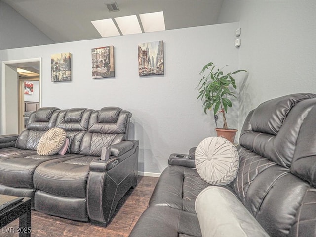 living room featuring vaulted ceiling and dark hardwood / wood-style flooring