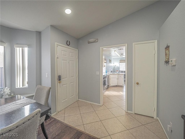 office space with plenty of natural light, lofted ceiling, and light tile patterned floors