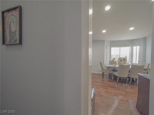 hallway with dark hardwood / wood-style flooring