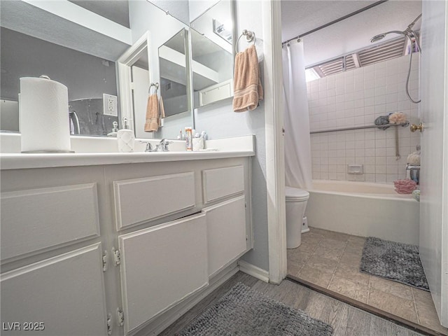 full bathroom featuring vanity, wood-type flooring, shower / bath combination with curtain, and toilet