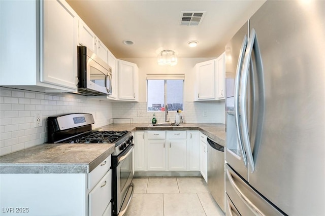 kitchen with sink, white cabinets, and appliances with stainless steel finishes