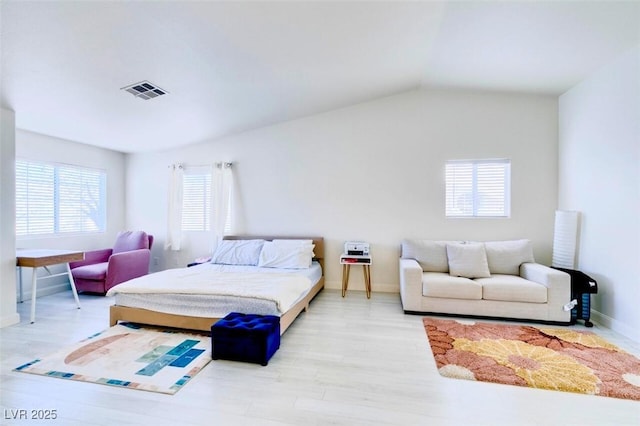 bedroom featuring vaulted ceiling and light hardwood / wood-style flooring