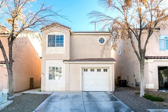 view of front of house featuring a garage and central AC