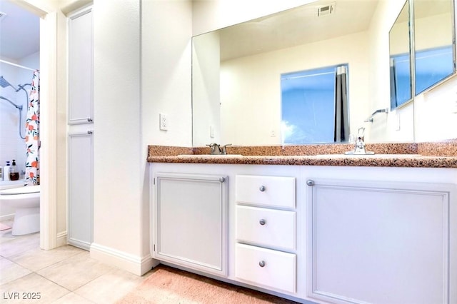 full bathroom featuring tile patterned floors, vanity, toilet, and shower / bath combo with shower curtain