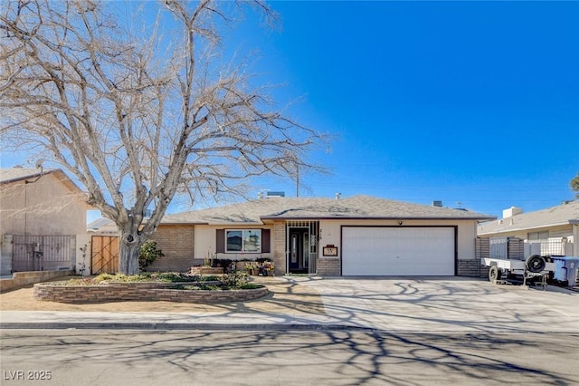 ranch-style home with a garage, concrete driveway, and brick siding