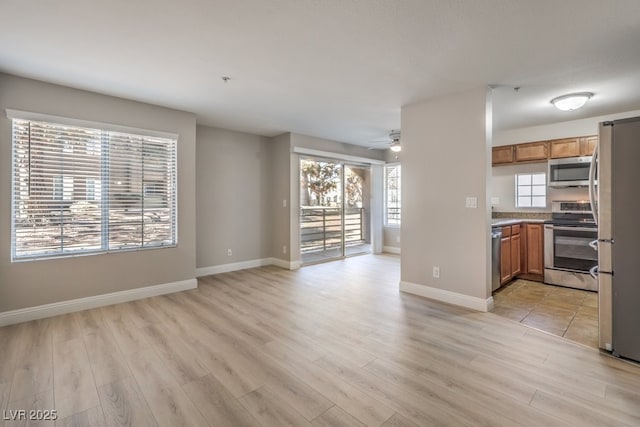 kitchen featuring light hardwood / wood-style flooring, stainless steel appliances, and ceiling fan