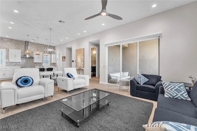 2503 Cracked Stone St, Henderson, NV 89044 - living room with ceiling fan with notable chandelier, visible vents, and recessed lighting
