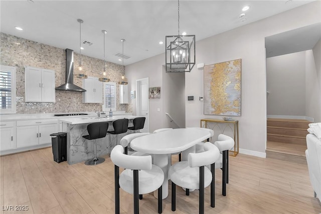 2503 Cracked Stone St, Henderson, NV 89044 - dining area with light wood finished floors, baseboards, visible vents, and a wealth of natural light