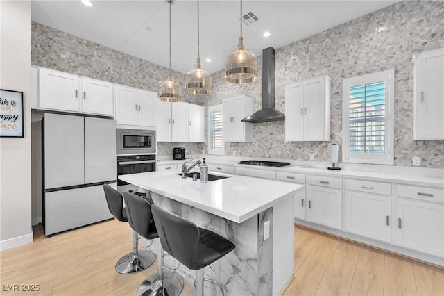 2503 Cracked Stone St, Henderson, NV 89044 - kitchen with white cabinets, wall chimney exhaust hood, appliances with stainless steel finishes, and light countertops