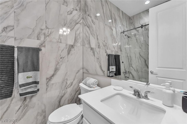 2503 Cracked Stone St, Henderson, NV 89044 - bathroom with tile walls, toilet, vanity, and a marble finish shower