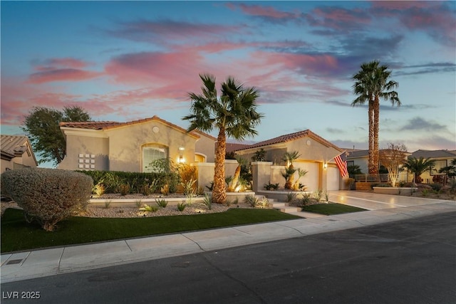 4796 Riva De Romanza St, Las Vegas, NV 89135 - mediterranean / spanish-style house with an attached garage, stucco siding, driveway, and a tiled roof
