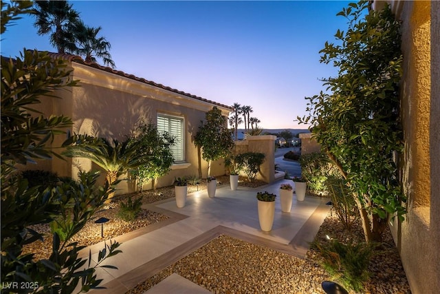 4796 Riva De Romanza St, Las Vegas, NV 89135 - yard at dusk with a patio area