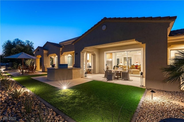 4796 Riva De Romanza St, Las Vegas, NV 89135 - rear view of property with a patio, stucco siding, a tile roof, and area for grilling