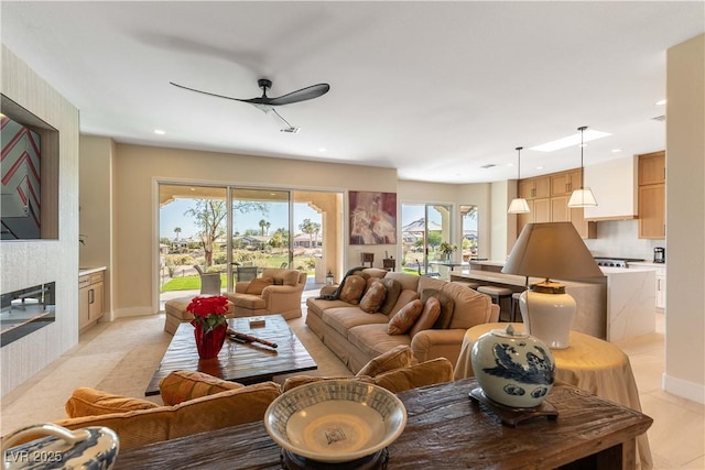 4796 Riva De Romanza St, Las Vegas, NV 89135 - living area with a ceiling fan, recessed lighting, light tile patterned floors, and a fireplace