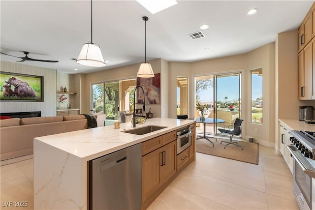 4796 Riva De Romanza St, Las Vegas, NV 89135 - kitchen featuring appliances with stainless steel finishes, plenty of natural light, an island with sink, pendant lighting, and recessed lighting