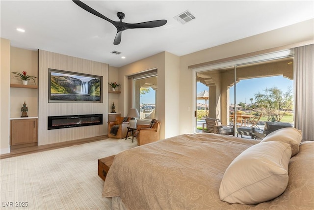 4796 Riva De Romanza St, Las Vegas, NV 89135 - bedroom with access to exterior, a large fireplace, ceiling fan, and recessed lighting