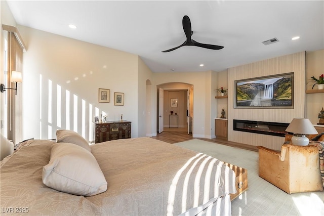 4796 Riva De Romanza St, Las Vegas, NV 89135 - bedroom with arched walkways, recessed lighting, a ceiling fan, and light carpet