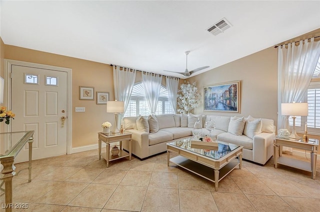 tiled living room with ceiling fan and vaulted ceiling