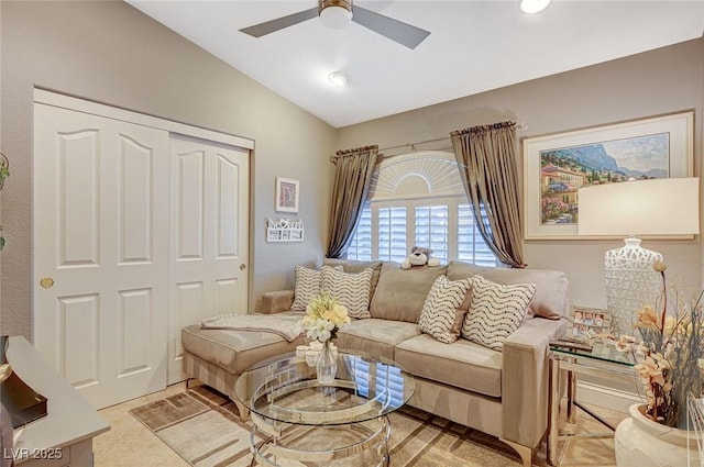 living room featuring lofted ceiling, ceiling fan, and light tile patterned floors