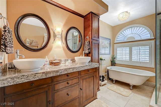 bathroom featuring a bath, tile patterned floors, and vanity