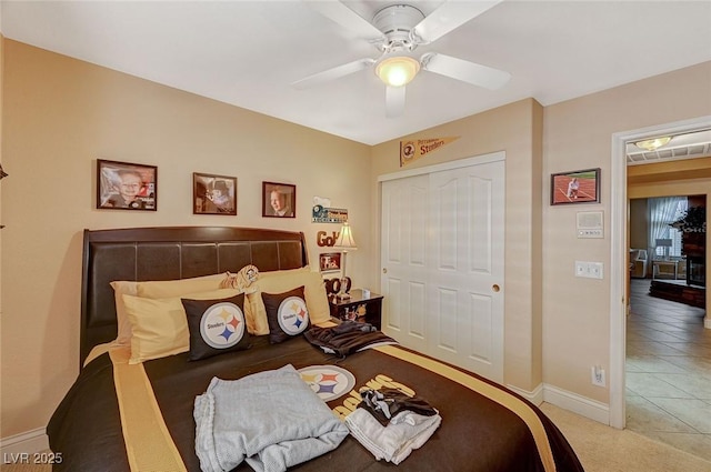 tiled bedroom featuring a closet and ceiling fan