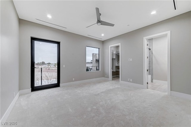 unfurnished bedroom featuring a walk in closet, access to outside, light carpet, and ceiling fan