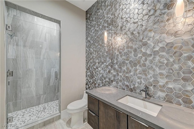 bathroom featuring vanity, toilet, and an enclosed shower