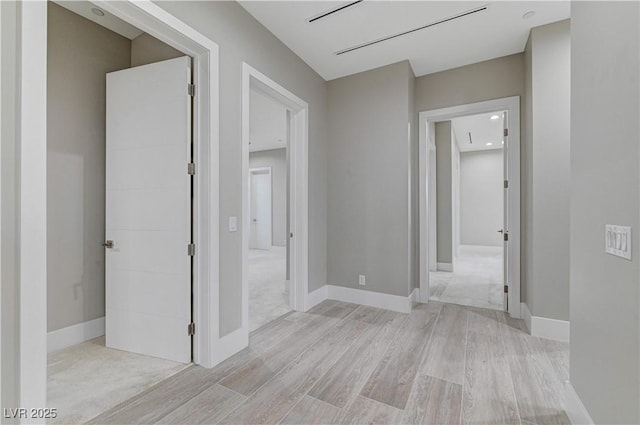 corridor with light wood-type flooring