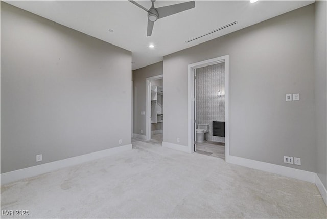 empty room featuring ceiling fan and light colored carpet