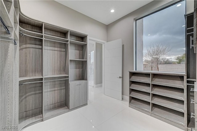 walk in closet featuring light tile patterned flooring