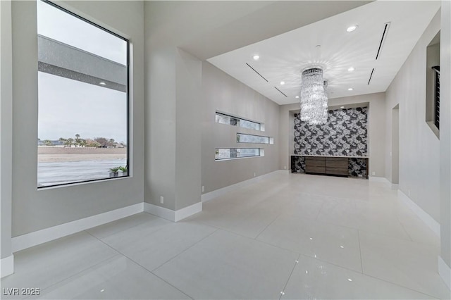 interior space with light tile patterned flooring and a notable chandelier