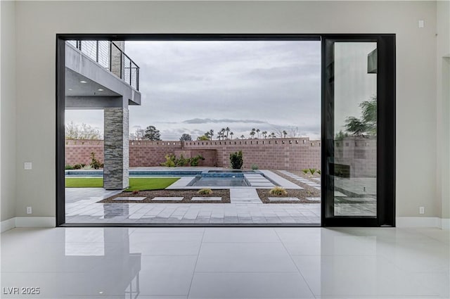 doorway to outside with tile patterned flooring