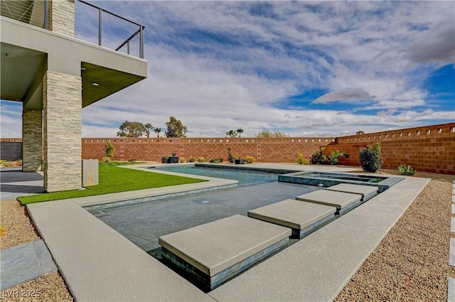 view of swimming pool featuring an in ground hot tub