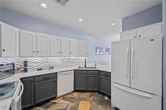 262 Big Horn Dr, Boulder City, NV 89005 - kitchen with white appliances, gray cabinetry, white cabinetry, stone tile floors, and backsplash