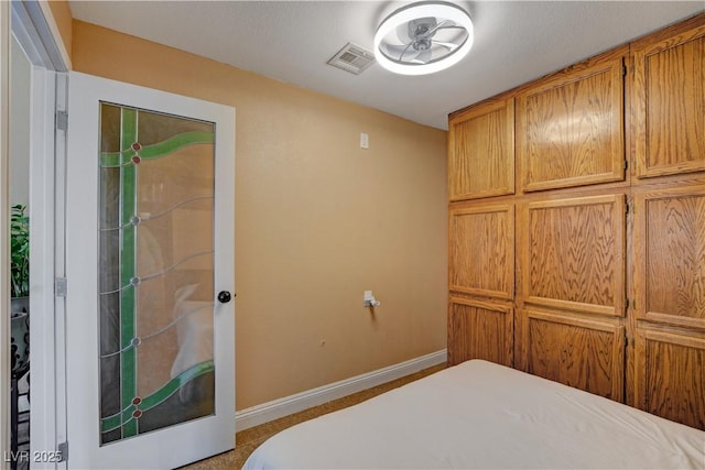 bedroom with visible vents and baseboards