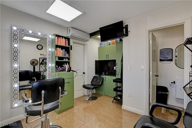 office featuring a wall unit AC, baseboards, and light floors