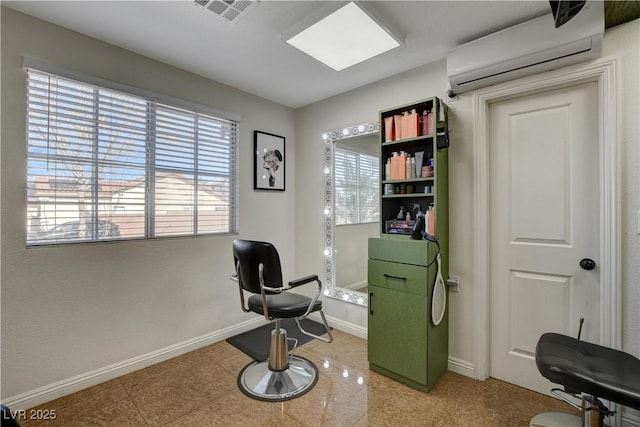 sitting room with a wall mounted AC, visible vents, and baseboards