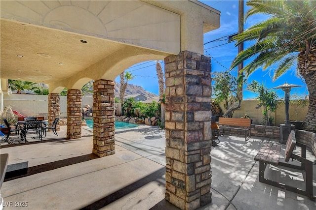 view of patio / terrace featuring a fenced in pool and fence