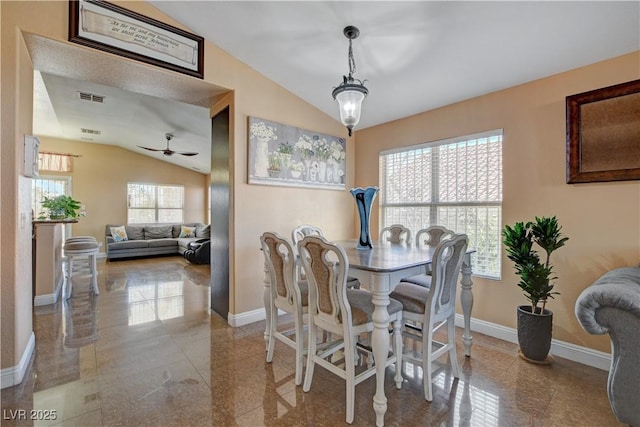 dining room with visible vents, baseboards, ceiling fan, and lofted ceiling