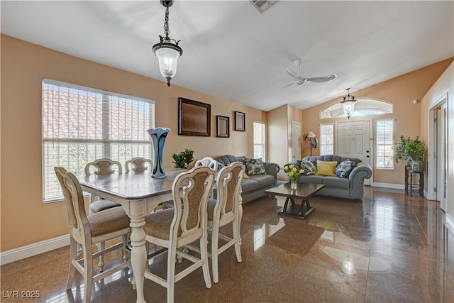 dining space featuring a wealth of natural light, baseboards, and vaulted ceiling