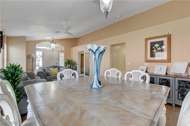 dining room featuring vaulted ceiling and a ceiling fan