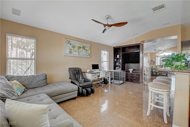 living room featuring visible vents, a ceiling fan, granite finish floor, and vaulted ceiling