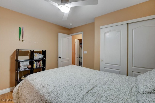 bedroom featuring a closet, baseboards, light wood-type flooring, and a ceiling fan