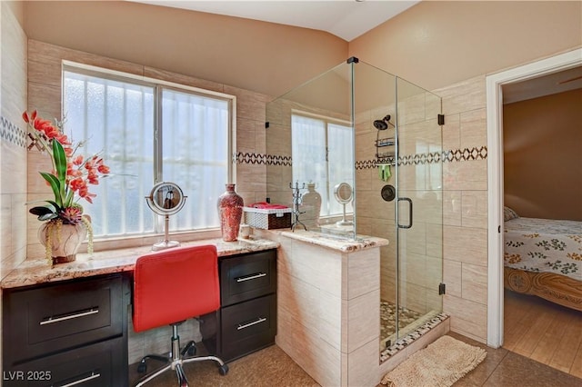 full bathroom with a shower stall, vanity, and connected bathroom