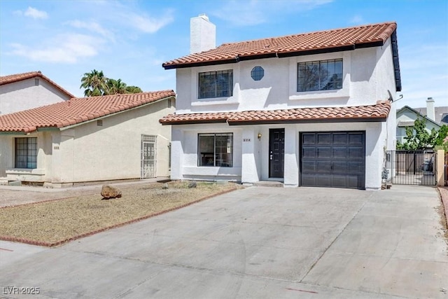 mediterranean / spanish home with a garage